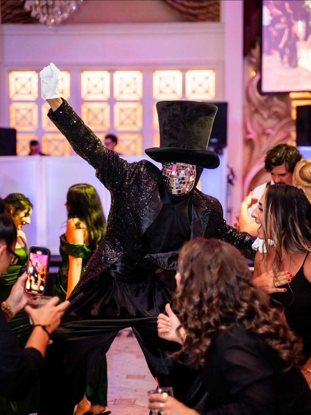 Stilt performer hyping up the crowd as guests film on their phones