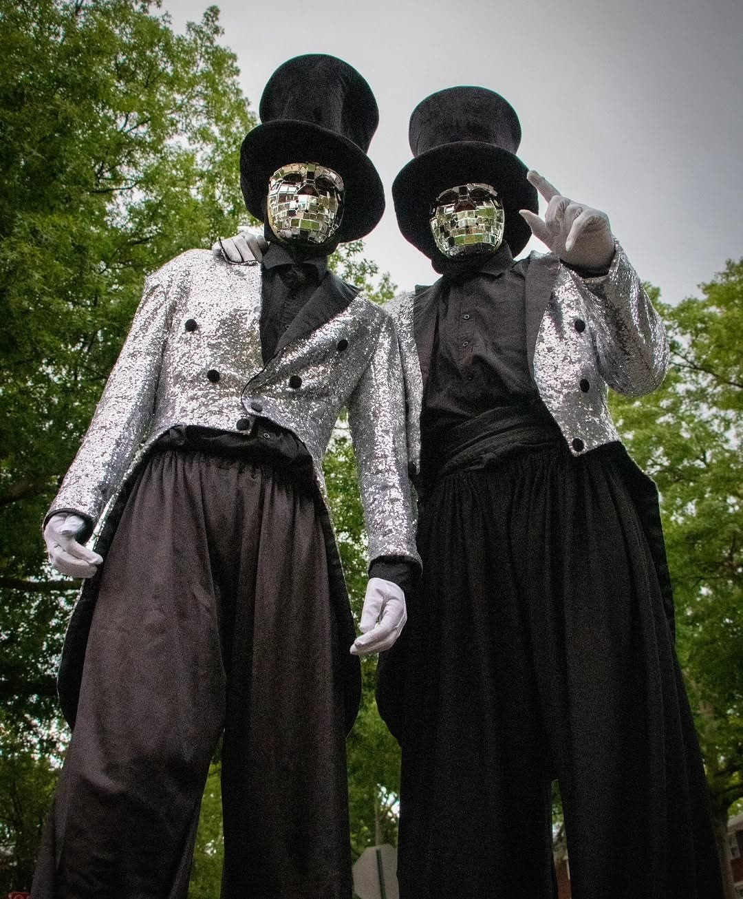 New Hiights stilt performers in top hats and sequin jackets